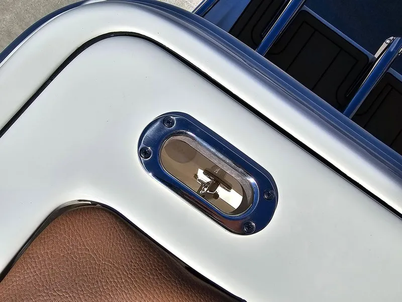 Slide: The Image of Close-up of a 2025 Pioneer 222 Sportfish boat detail, featuring sleek metallic and leather elements. - 37