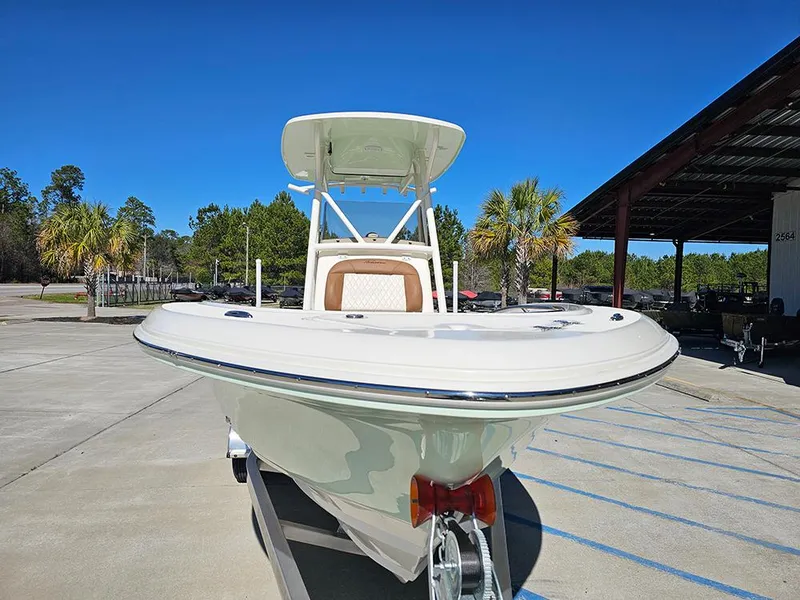 Slide: The Image of 2025 Pioneer 222 Sportfish boat on trailer, parked outdoors under clear blue sky. - 4