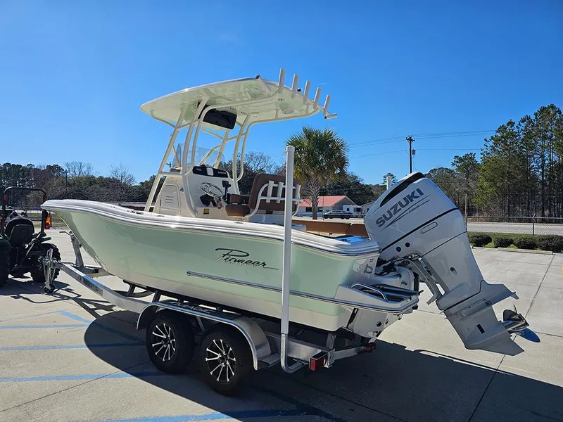 Slide: The Image of 2025 Pioneer 222 Sportfish boat with Suzuki engine on trailer, parked outdoors. - 7