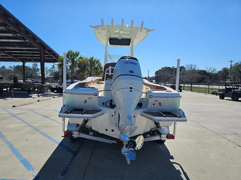 Slide: The Image of 2025 Pioneer 222 Sportfish boat, rear view, parked outdoors on a sunny day. - 8