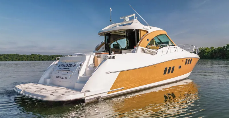 Slide: The Image of 2006 Sea Ray 60 Sundancer yacht on calm water, featuring sleek design and modern amenities. - 0