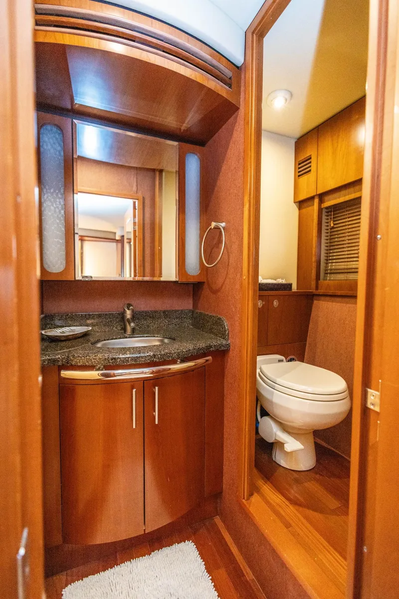 Slide: The Image of Luxurious bathroom in 2006 Sea Ray 60 Sundancer yacht with wood accents and modern fixtures. - 32