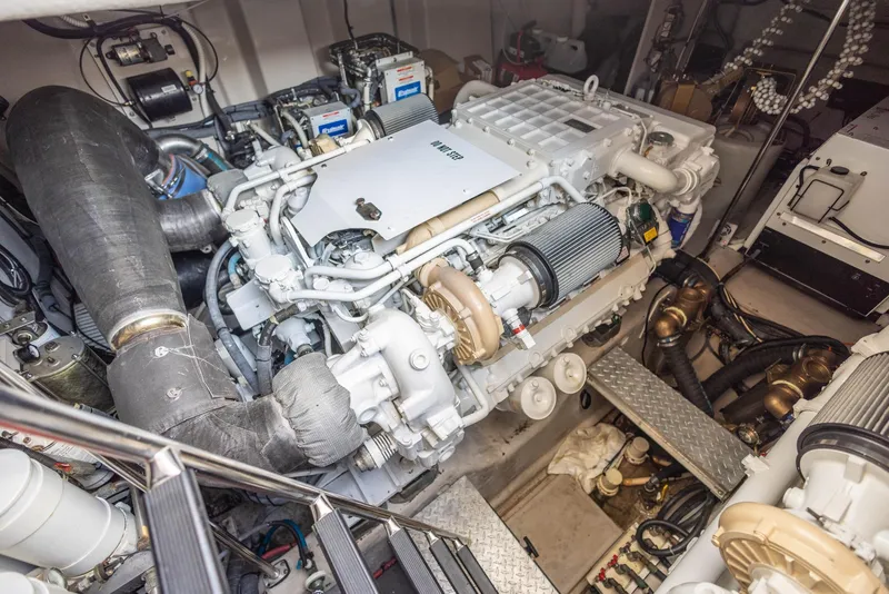 Slide: The Image of Engine room of 2006 Sea Ray 60 Sundancer yacht, showcasing detailed mechanical components. - 36