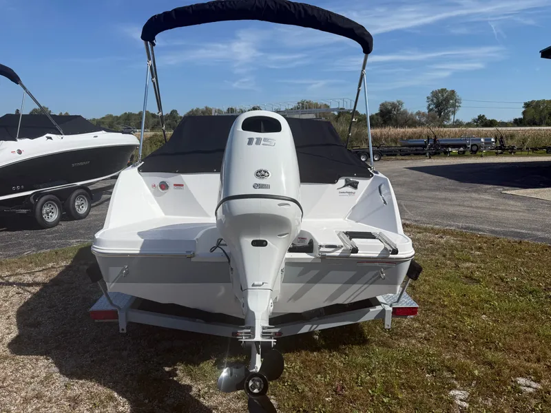 Slide: The Image of 2025 Stingray 172DC boat with outboard motor, parked on a trailer in a sunny outdoor setting. - 12