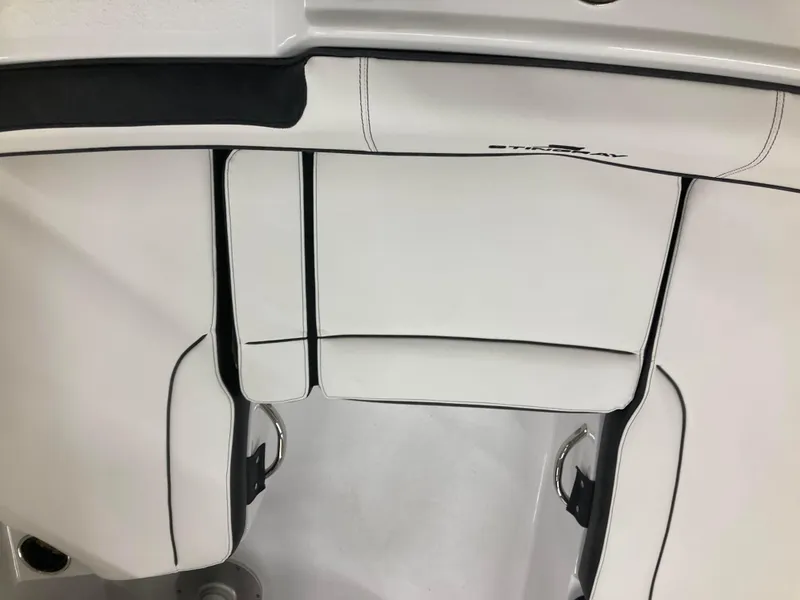 Slide: The Image of Interior of 2025 Stingray 172DC boat, featuring dashboard and cup holders. - 7
