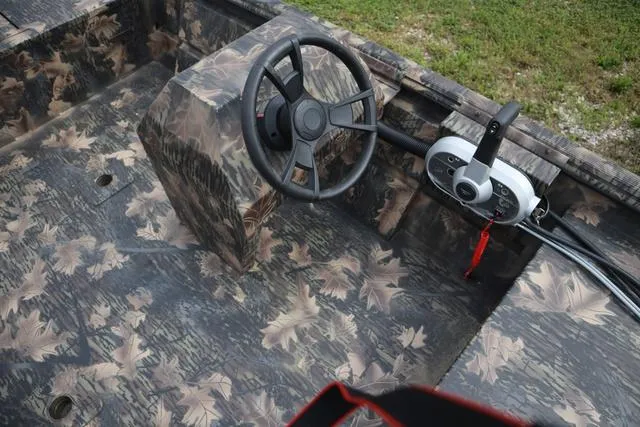 Slide: The Image of 2024 Lowe Roughneck 1660 Add on Console Jet with camouflage interior design. - 4