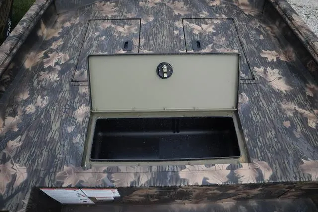 Slide: The Image of 2024 Lowe Roughneck 1660 Add on Console Jet with open storage compartment, camo design. - 5