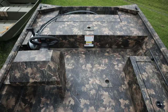 Slide: The Image of 2024 Lowe Roughneck 1660 Add on Console Jet boat with camouflage interior design. - 8
