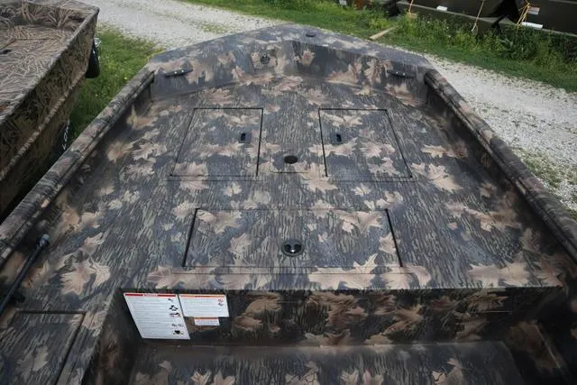 Slide: The Image of 2024 Lowe Roughneck 1660 Add on Console Jet boat with camouflage design. - 9