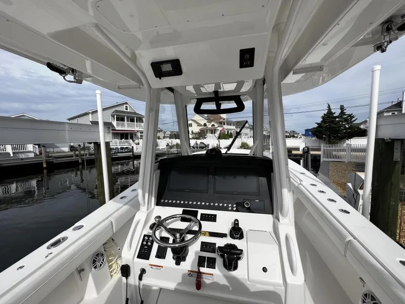 Slide: The Image of 2022 Regulator 34 boat cockpit with steering wheel and control panel. - 4