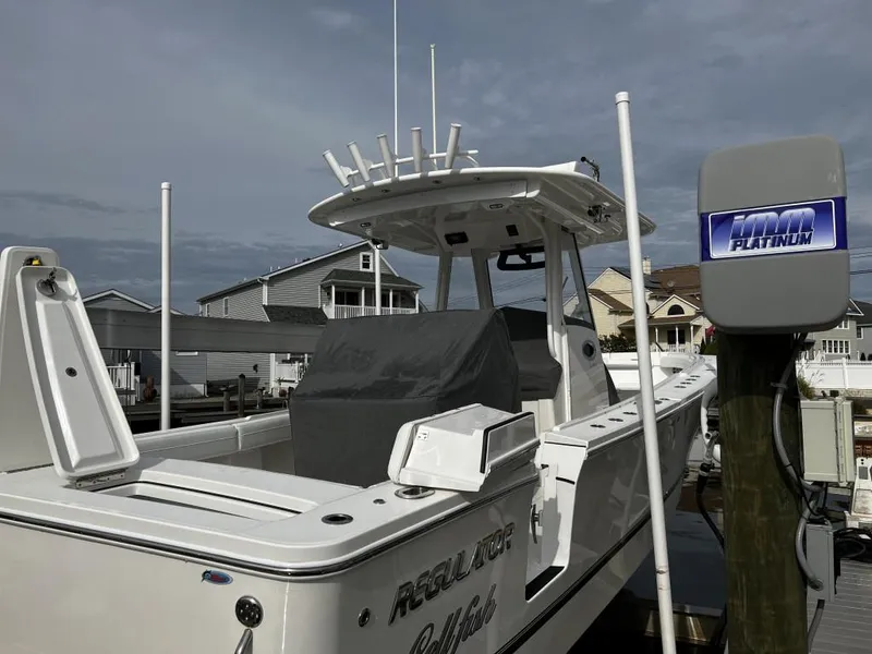 Slide: The Image of 2022 Regulator 34 boat docked, featuring sleek design and modern amenities. - 8