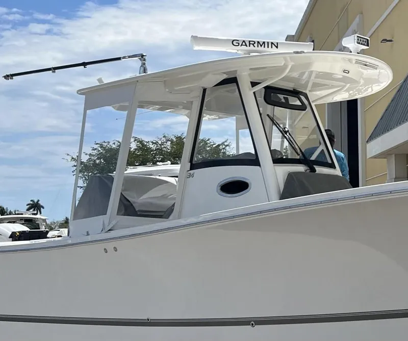 Slide: The Image of 2022 Regulator 34 boat with Garmin equipment, docked near a building. - 9