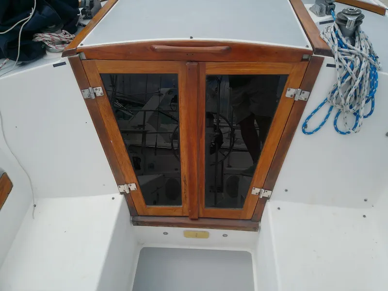 Slide: The Image of Wooden hatch doors on a 1990 Catalina 30 MkII sailboat deck. - 10