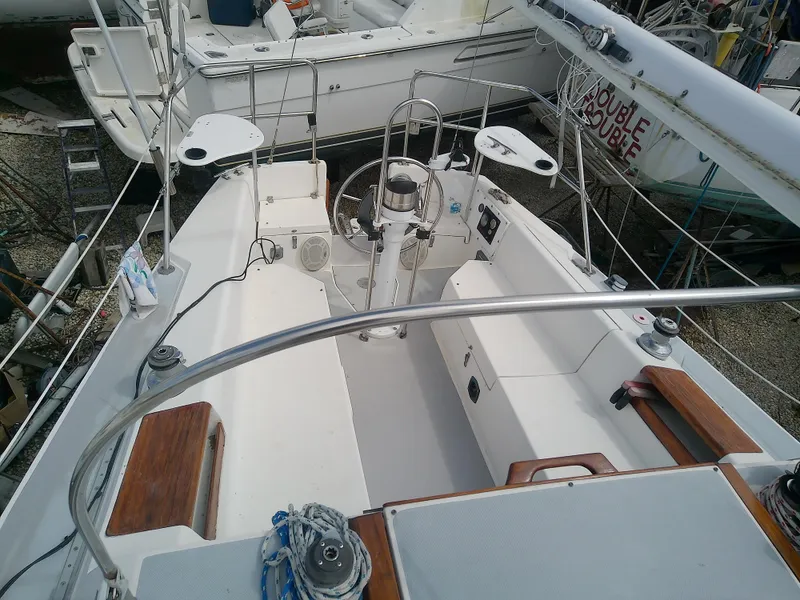 Slide: The Image of Cockpit of a 1990 Catalina 30 MkII sailboat with steering wheel and seating. - 14