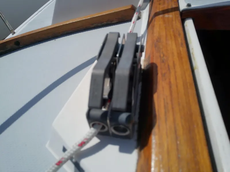 Slide: The Image of Close-up of a rope cleat on a 1990 Catalina 30 MkII sailboat deck. - 22