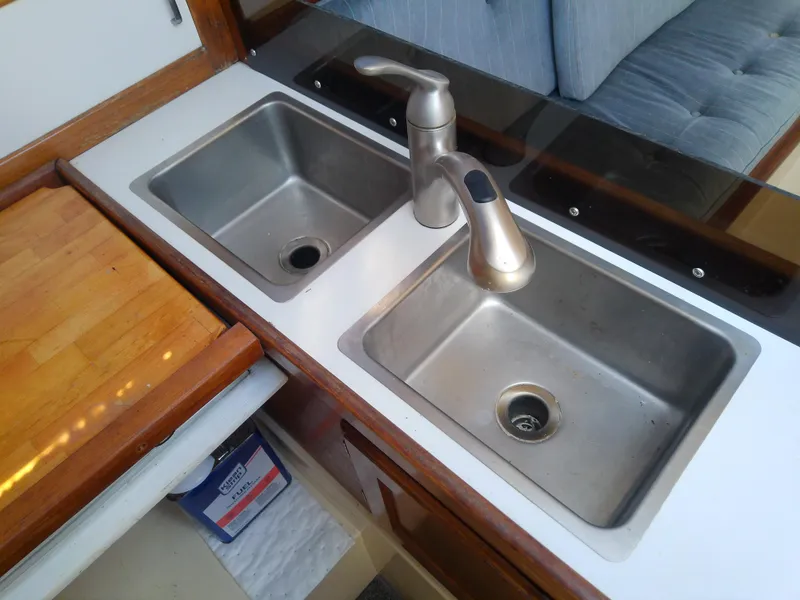 Slide: The Image of Double sink with modern faucet in 1990 Catalina 30 MkII yacht kitchen. - 28