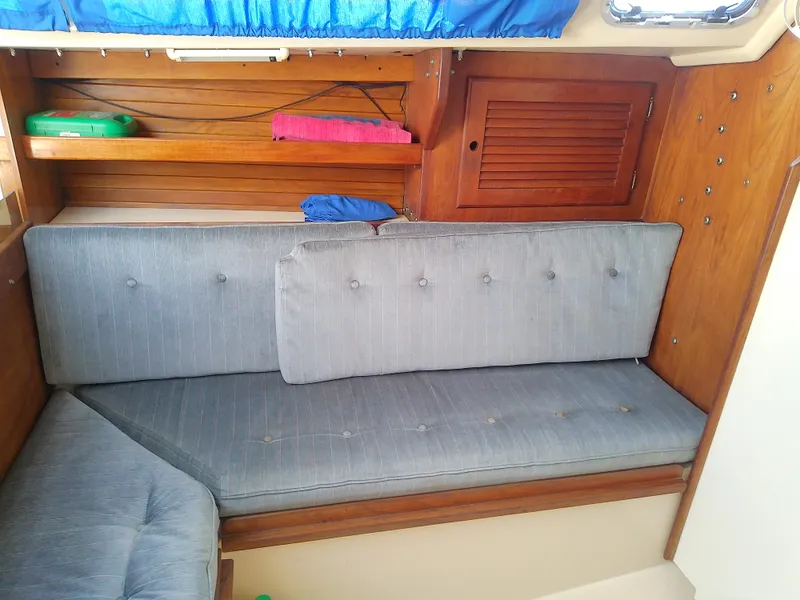 Slide: The Image of Interior of a 1990 Catalina 30 MkII sailboat with blue cushions and wooden cabinetry. - 37