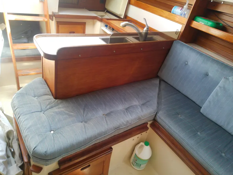 Slide: The Image of Interior of 1990 Catalina 30 MkII sailboat with blue cushions and wooden cabinetry. - 39