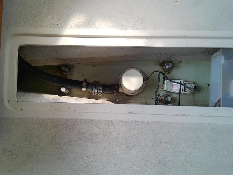 Slide: The Image of Bilge compartment of a 1990 Catalina 30 MkII sailboat showing hose and fittings. - 44