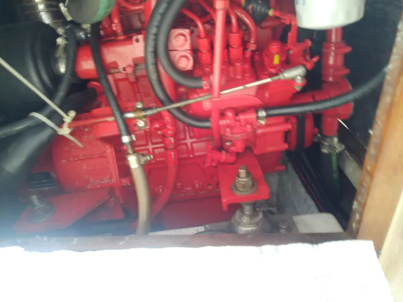 Slide: The Image of Engine compartment of a 1990 Catalina 30 MkII sailboat, featuring a red engine. - 49