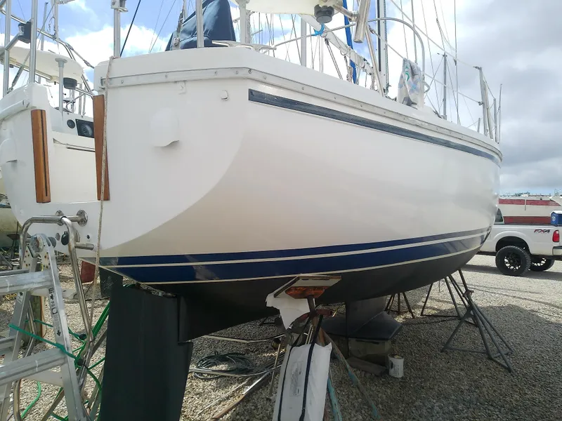 Slide: The Image of 1990 Catalina 30 MkII sailboat on dry dock, showcasing hull and keel. - 5