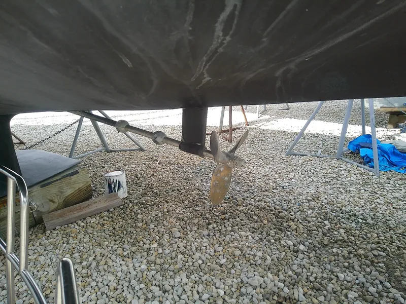 Slide: The Image of Catalina 30 MkII 1990 sailboat underbody with propeller, on gravel surface. - 6