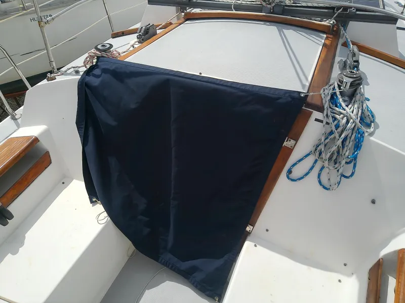 Slide: The Image of 1990 Catalina 30 MkII sailboat cockpit with navy cover and coiled ropes. - 8