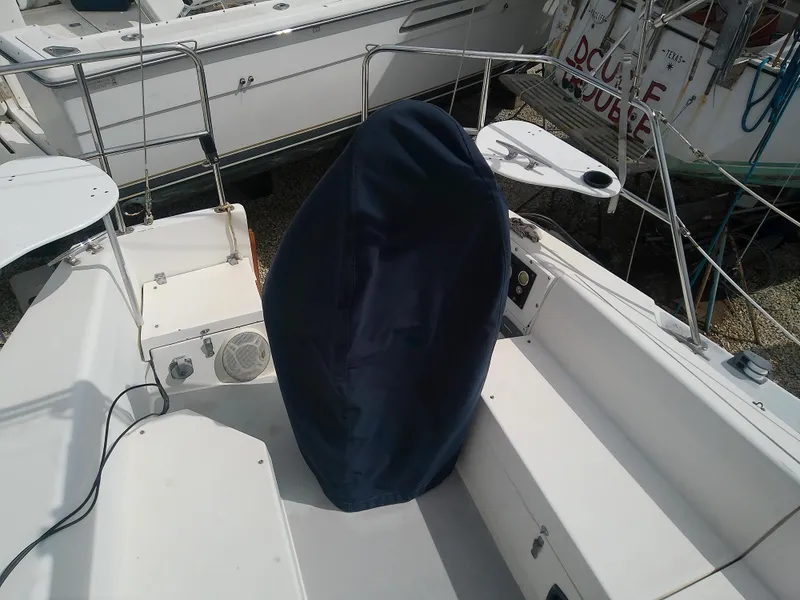 Slide: The Image of 1990 Catalina 30 MkII sailboat cockpit with covered wheel, docked. - 9