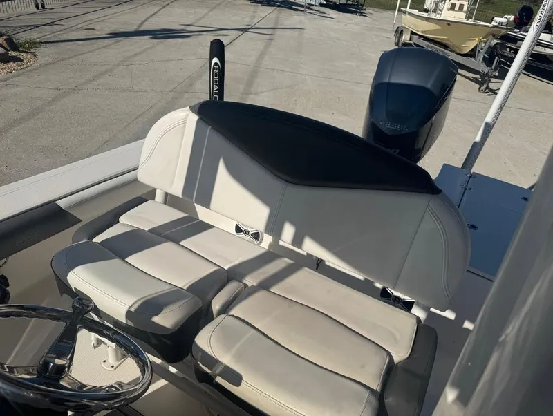 Slide: The Image of 2018 Robalo 246 Cayman boat interior with cushioned seating and steering wheel. - 10