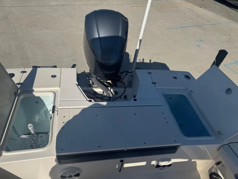 Slide: The Image of 2018 Robalo 246 Cayman boat deck with motor and storage compartments. - 12