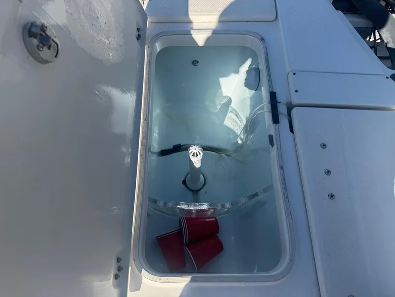 Slide: The Image of Livewell on 2018 Robalo 246 Cayman boat with red cups inside. - 13