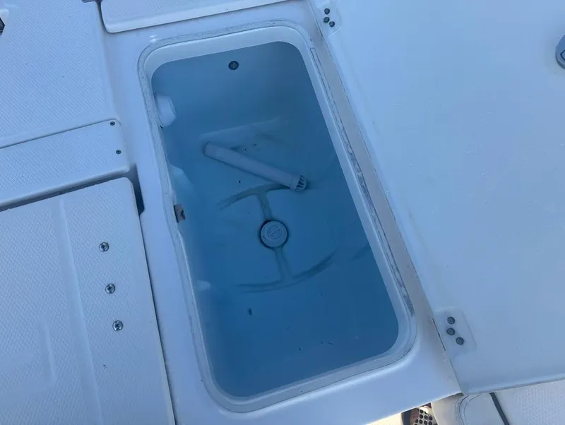 Slide: The Image of 2018 Robalo 246 Cayman boat storage compartment, open and empty. - 14