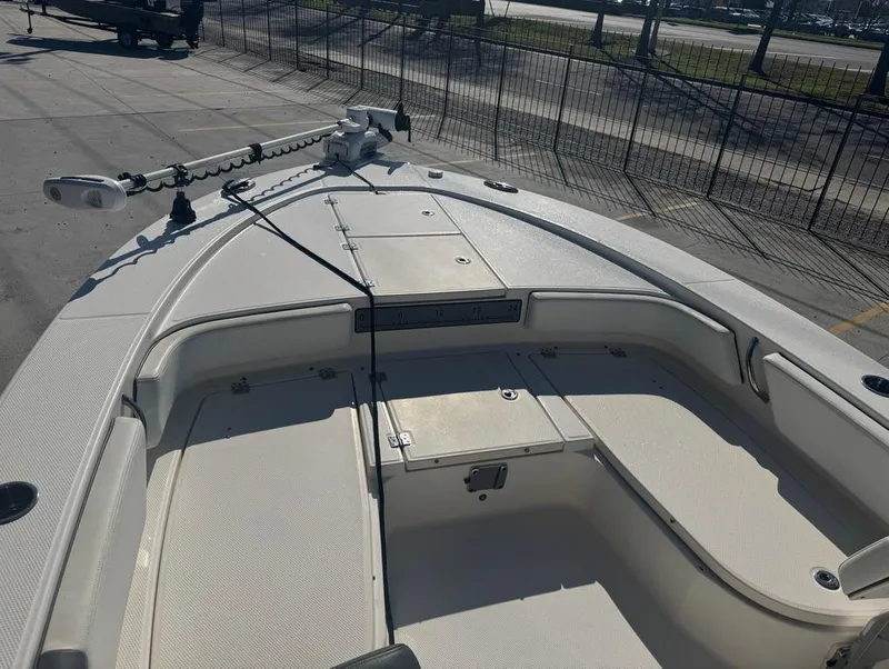 Slide: The Image of 2018 Robalo 246 Cayman boat deck with storage compartments and trolling motor. - 15