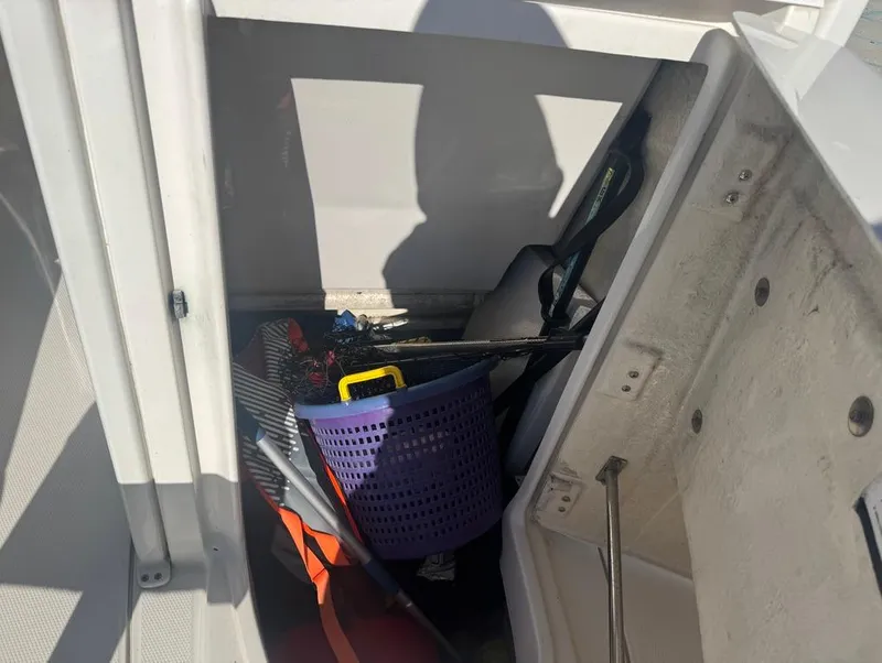 Slide: The Image of Storage compartment of a 2018 Robalo 246 Cayman boat with fishing gear and accessories. - 17