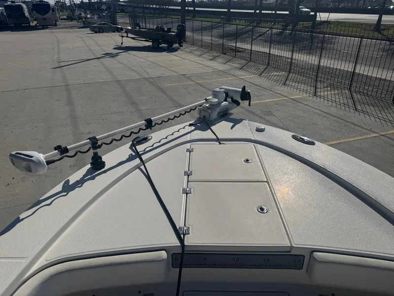 Slide: The Image of 2018 Robalo 246 Cayman boat deck with mounted equipment in a parking area. - 18