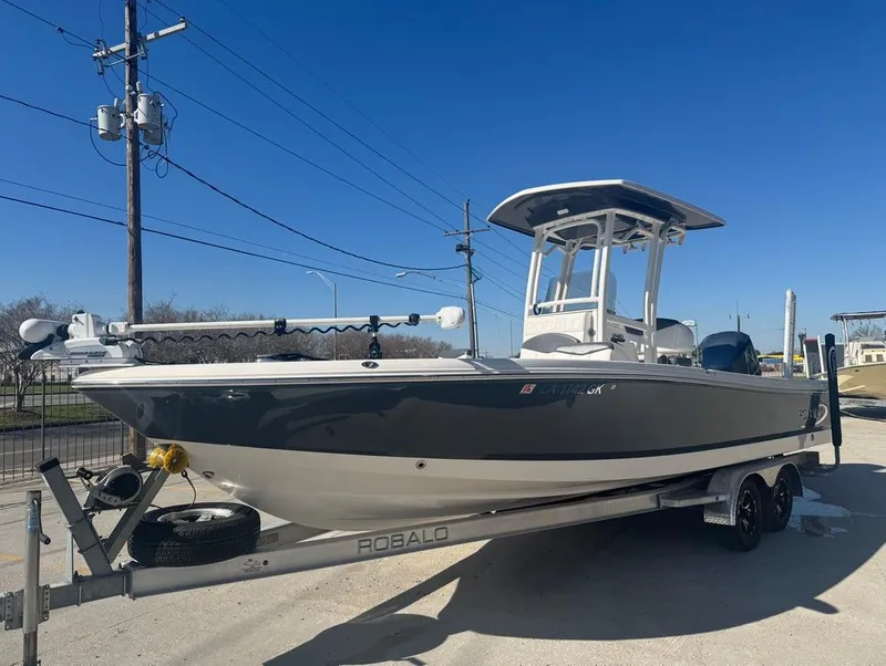 Slide: The Image of 2018 Robalo 246 Cayman boat on trailer under clear blue sky. - 3