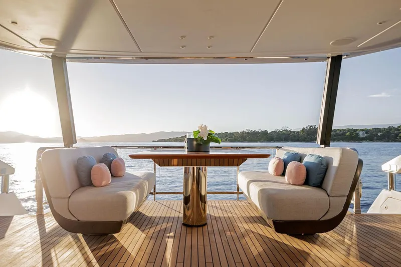 Slide: The Image of Luxurious 2025 Azimut Grande 26M yacht deck with elegant seating and scenic ocean view. - 15