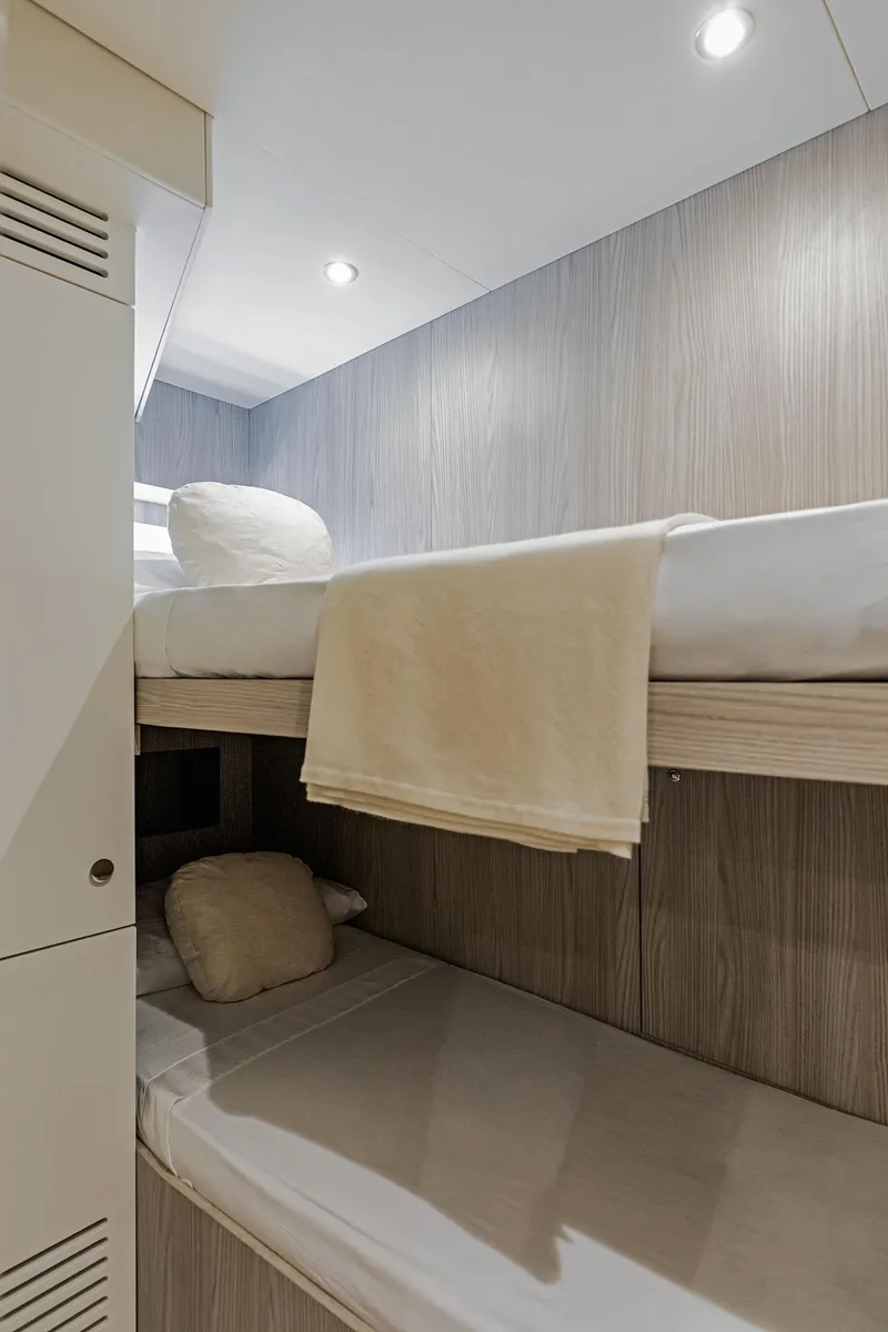 Slide: The Image of Bunk beds in 2025 Azimut Grande 26M yacht cabin, modern design, cozy lighting. - 34