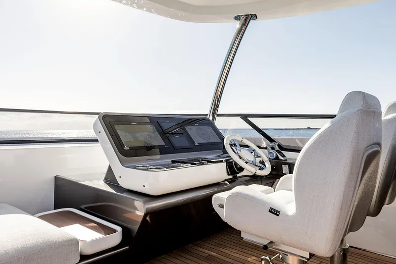 Slide: The Image of Helm of 2025 Azimut Grande 26M yacht with modern controls and seating. - 35