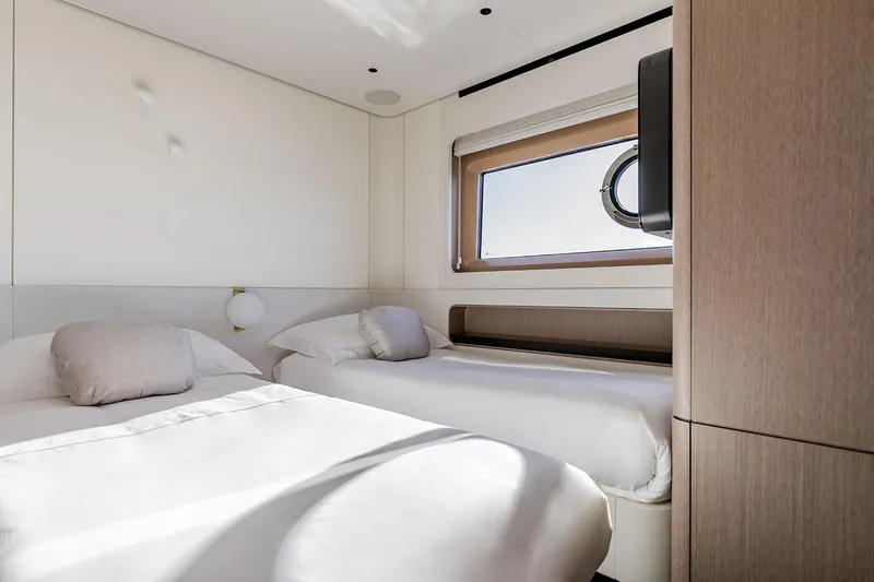 Slide: The Image of Luxurious cabin interior of 2025 Azimut Grande 26M yacht with twin beds and window view. - 47