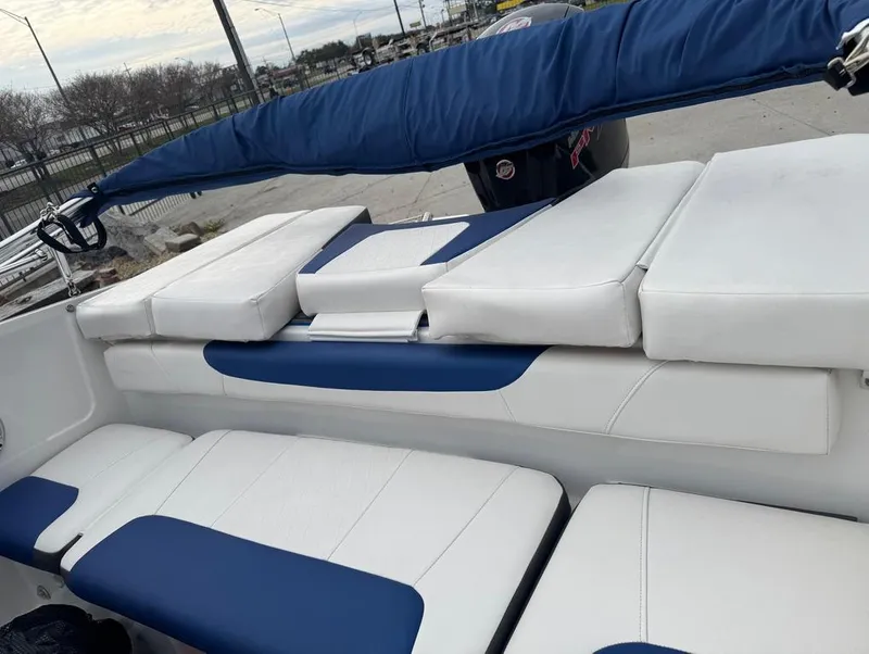 Slide: The Image of 2022 Tahoe 185 S boat interior with white and blue cushioned seating. - 10