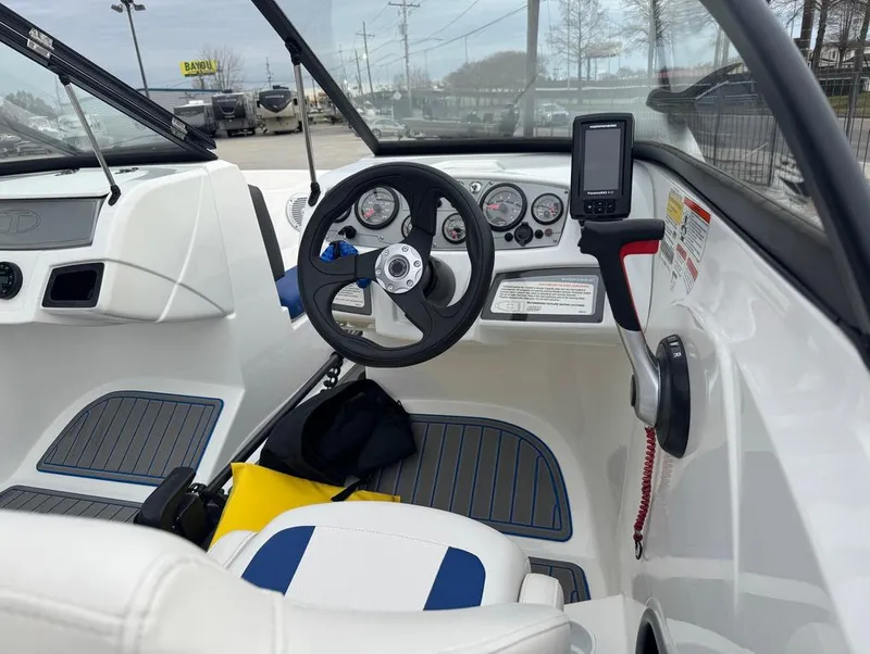 Slide: The Image of Interior view of 2022 Tahoe 185 S boat with steering wheel and dashboard controls. - 12