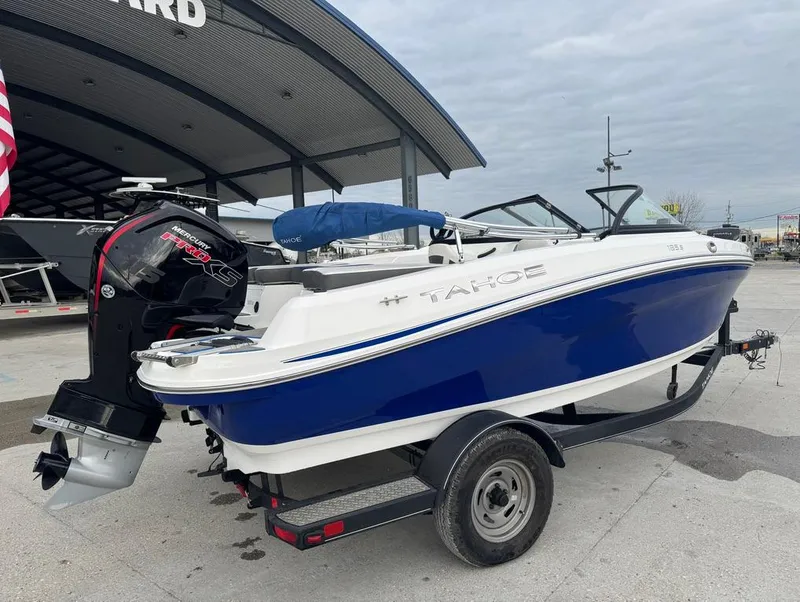 Slide: The Image of 2022 Tahoe 185 S boat with blue and white design on a trailer. - 4