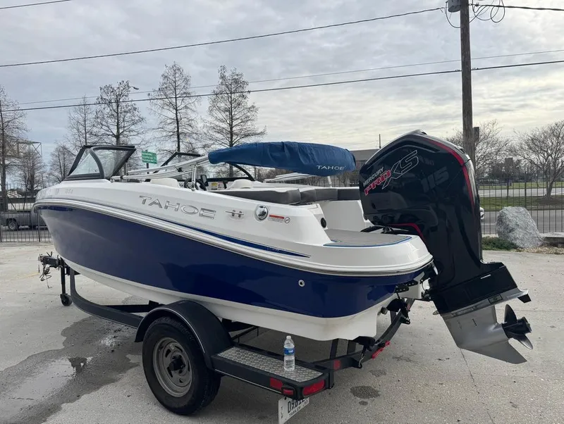 Slide: The Image of 2022 Tahoe 185 S boat on trailer with outboard motor, parked outdoors. - 6