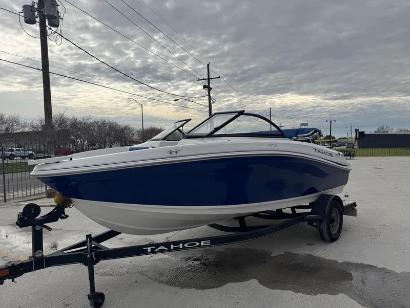 Slide: The Image of 2022 Tahoe 185 S boat on trailer, parked outdoors under cloudy sky. - 8
