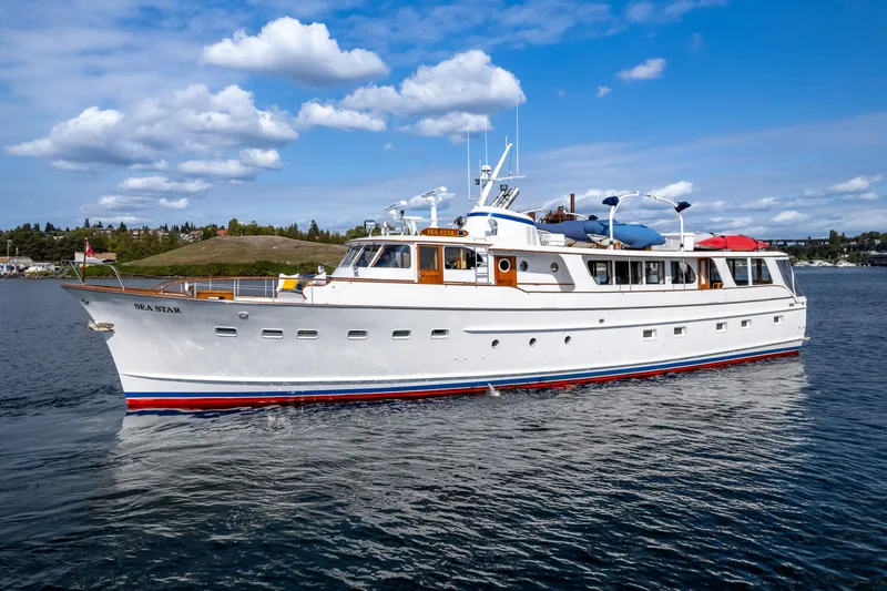 The Image of Classic 1965 Burger motoryacht cruising on a calm lake under a blue sky. - 1
