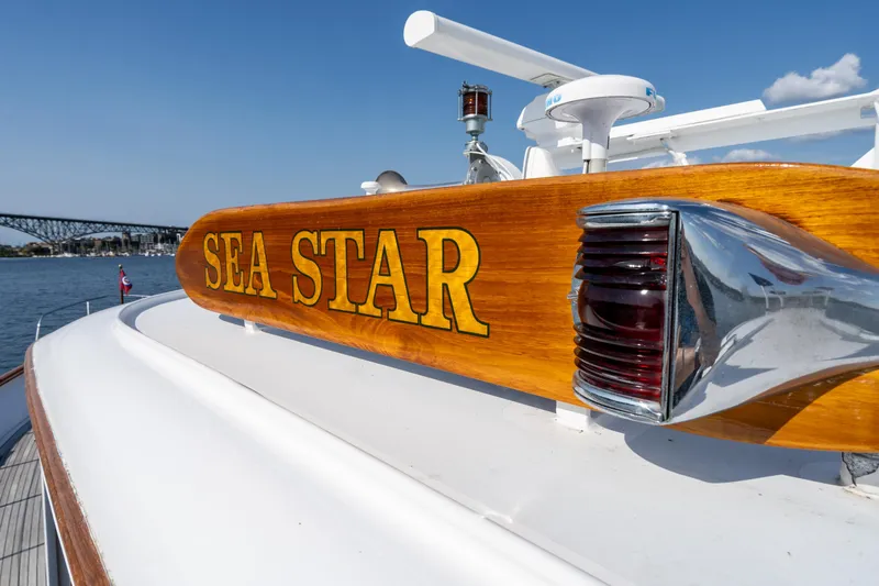 Slide: The Image of 1965 Burger Motoryacht "Sea Star" with wooden nameplate, docked under clear blue sky. - 11