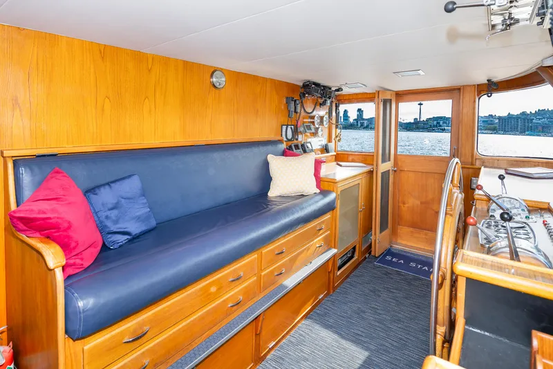 Slide: The Image of Interior of a 1965 Burger Motoryacht with wooden paneling and blue seating. - 21