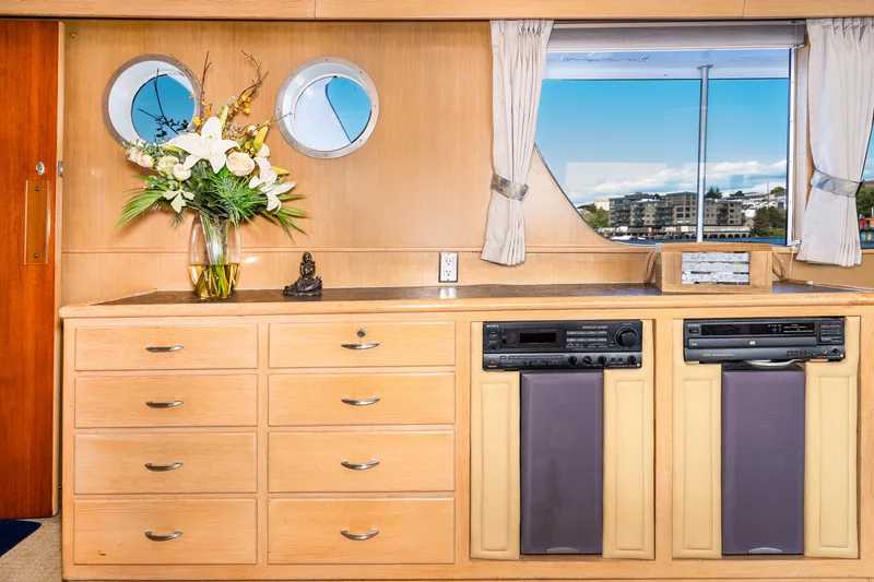 Slide: The Image of Interior of a 1965 Burger Motoryacht with wooden cabinetry and porthole windows. - 33