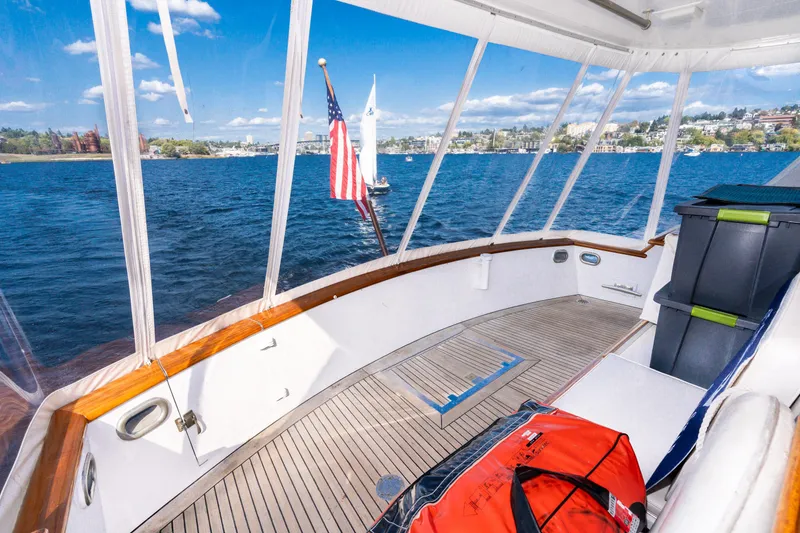 Slide: The Image of 1965 Burger Motoryacht deck with scenic water view and American flag. - 40